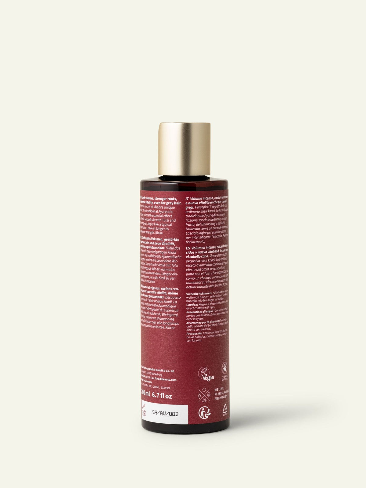 Parte posteriore del flacone di shampoo khadi Amla Volume con etichetta visibile.