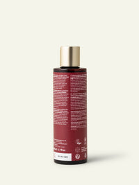 Parte posteriore del flacone di shampoo khadi Amla Volume con etichetta visibile.